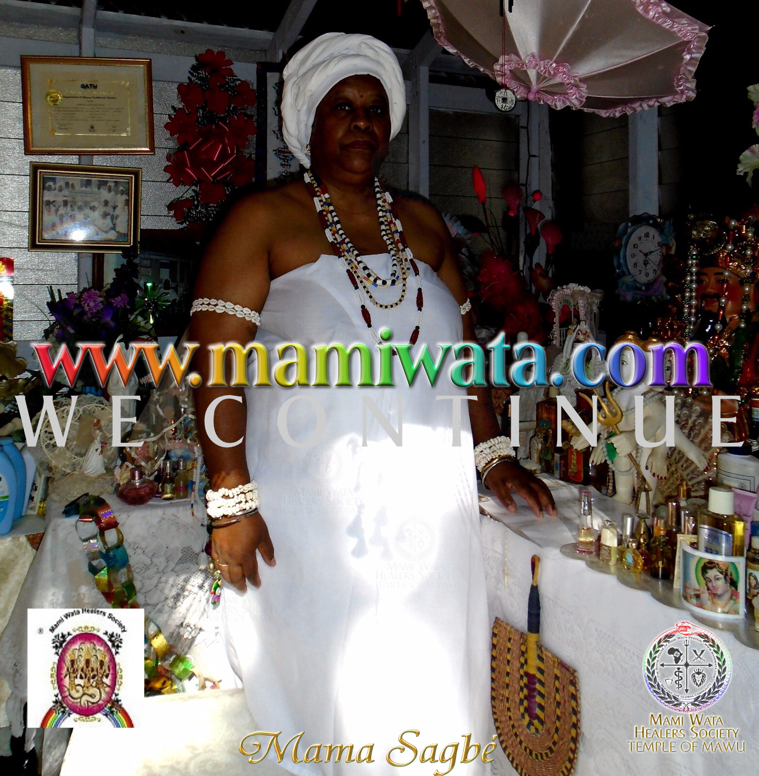 Mama Zogbe, wearing teal and custom spiritual regalia.